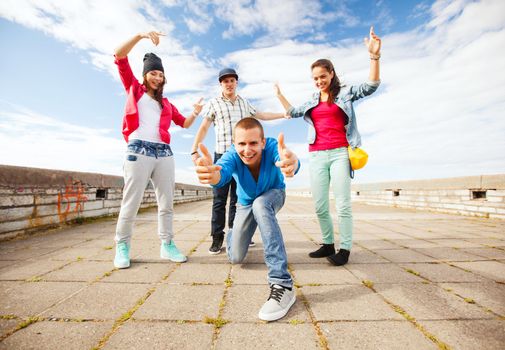 sport, dancing and urban culture concept - group of teenagers dancing