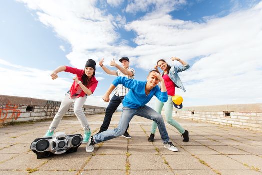 sport, dancing and urban culture concept - group of teenagers dancing