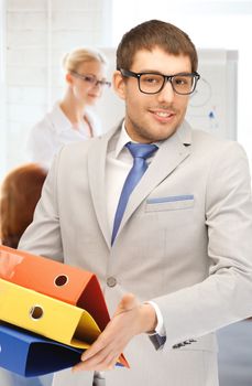 business concept - businessman with folders in office