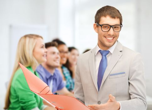 education concept - male teacher doing lecture at school