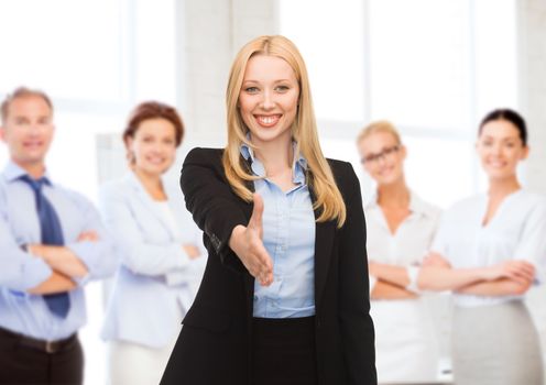 business concept - woman with an open hand ready for handshake