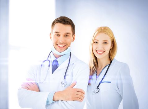 healthcare and medicine concept - two young attractive doctors