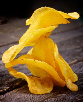 Arrangement of Crispy Cheese Potato Chips closeup on Rustic Wooden background