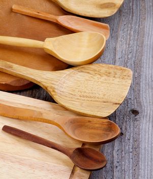 Arrangement of Wooden Spoons and Cutting Boards isolated on Rustic Wooden background