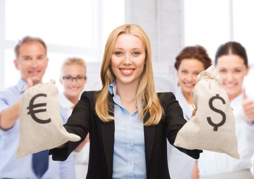 business and money - businesswoman holding money bags with dollars