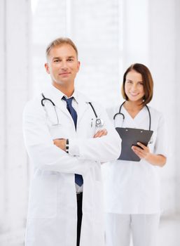 healthcare and medical concept - two doctors in hospital