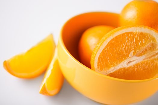 healthy food and cooking concept - orange in orange bowl
