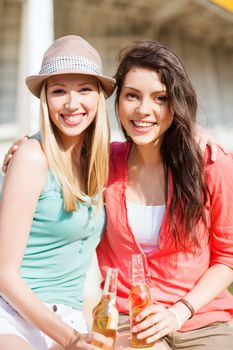 summer holidays and vacation - girls with drinks on the beach