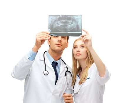 healthcare and medical concept - two doctors dentists looking at x-ray