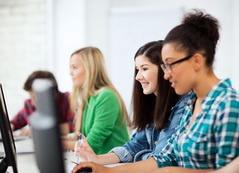 education, technology and internet - students with computers studying at school