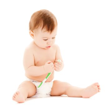 bright picture of curious baby brushing teeth.