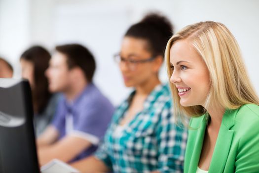 education, technology and internet - students with computers studying at school