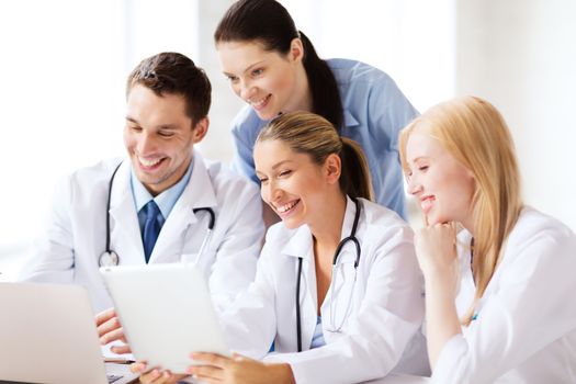 healthcare, medical and technology concept - group of doctors looking at tablet pc