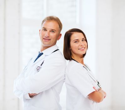 healthcare and medical concept - two doctors with stethoscopes