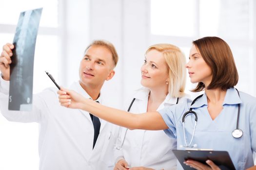 healthcare, medical and radiology concept - doctors looking at x-ray