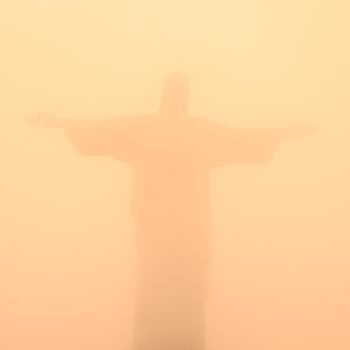 Christ the Redeemer Statue in misty sunset, Rio de Janeiro, Brazil.