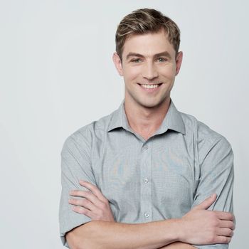 Confident casual young man with crossed arms