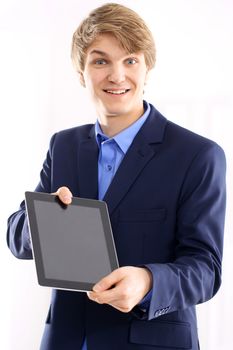 Portrait of a young elegant man in blue suit holding a digital tablet