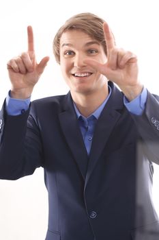 Portrait of a young elegant man in blue suit pointing his finger at the screen