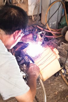 Welder working a welding metal and sparks 