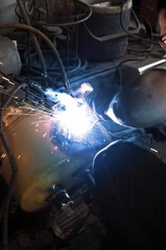 Welder working a welding metal and sparks