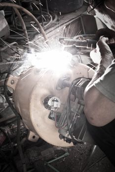 Welder working a welding metal and sparks