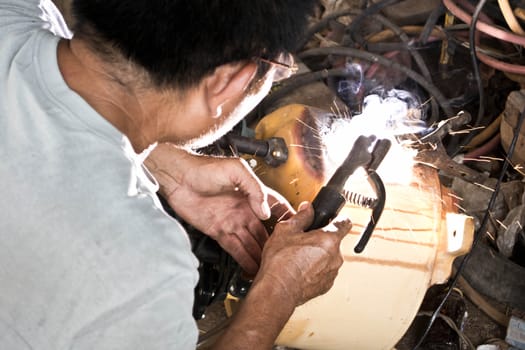 Welder working a welding metal and sparks