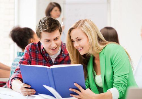 education concept - students reading book at school