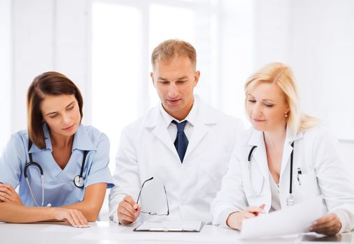 healthcare and medical concept - team or group of doctors on meeting