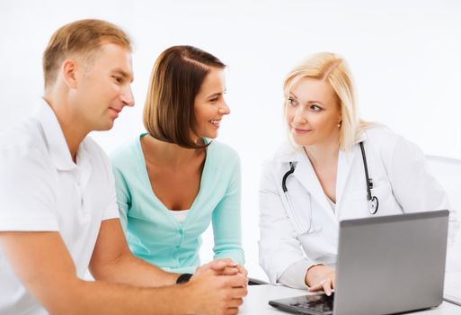 healthcare, medical and technology - doctor with patients looking at laptop