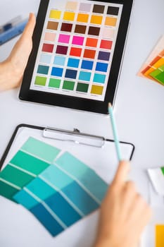 interior design, renovation and technology concept - woman working with color samples for selection