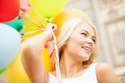 summer holidays, celebration and lifestyle concept - beautiful woman with colorful balloons in the city