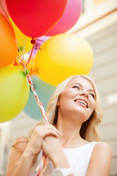 summer holidays, celebration and lifestyle concept - beautiful woman with colorful balloons in the city