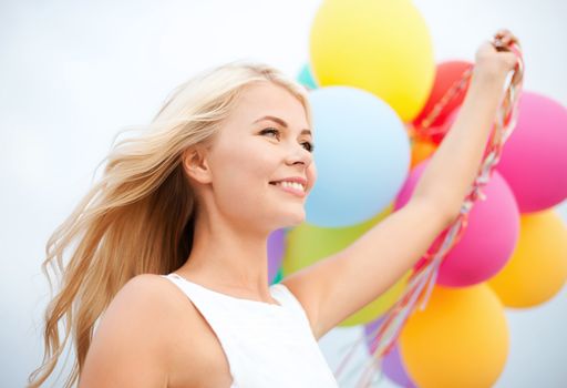 summer holidays, celebration and lifestyle concept - beautiful woman with colorful balloons outside