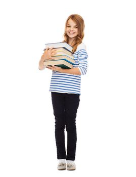 education and school concept - little student girl with many books