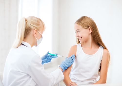 healthcare and medical concept - doctor doing vaccine to child in hospital