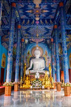 white Buddha image in temple hall,Chiangrai,Thailand