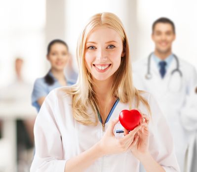healthcare and medical concept - female doctor with heart