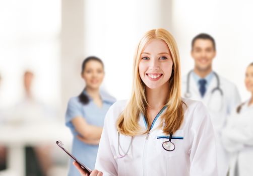 healthcare and medical concept - female doctor with stethoscope writing prescription