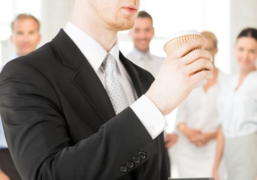business concept - man holding take away coffee cup