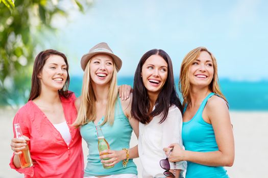 summer holidays and vacation - girls with drinks on the beach