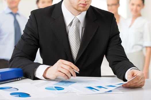 business concept - businessman working with papers