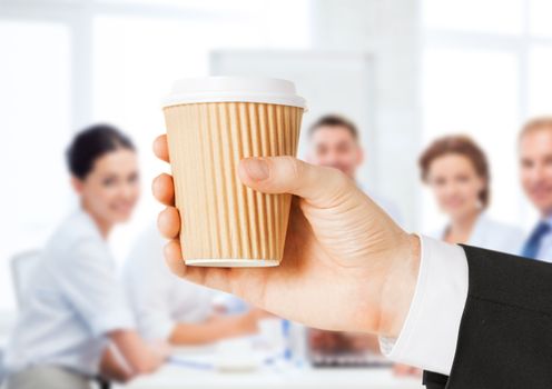 business concept - man holding take away coffee cup