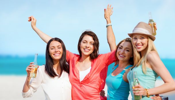 summer holidays and vacation - girls with drinks on the beach