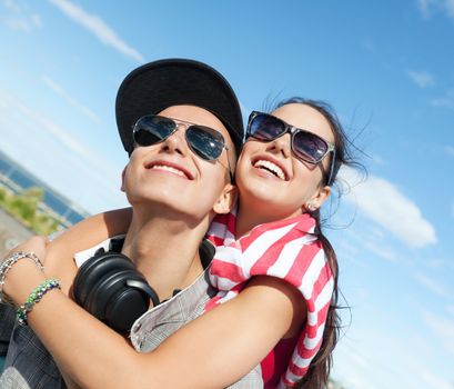 summer holidays and teenage concept - teenagers having fun outside