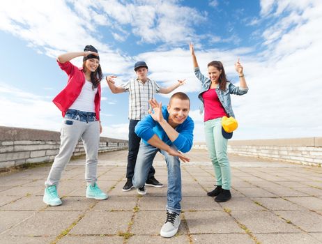 sport, dancing and urban culture concept - group of teenagers dancing