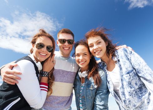 summer holidays and teenage concept - group of teenagers outside