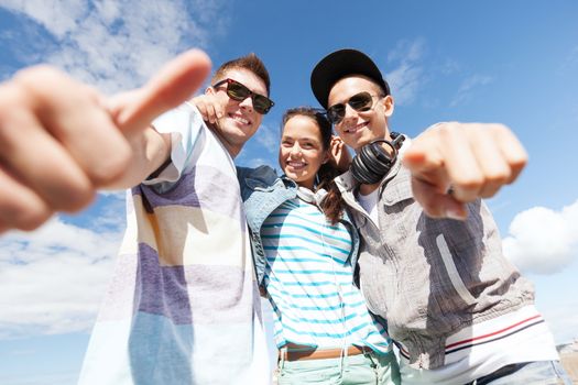 summer holidays and teenage concept - group of teenagers outside