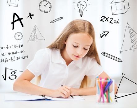 education and school concept - little student girl drawing at school