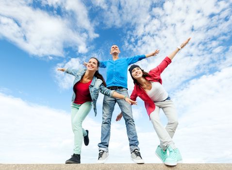 sport, dancing and urban culture concept - group of teenagers spreading hands